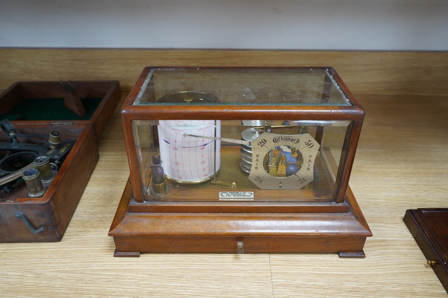 An oak cased barograph with integral barometer by Thomas Armstrong & Bro. Ltd. 78 Deansgate, Manchester, with bevelled glass panels and drawer to base, 37cm wide, 23cm deep, 22cm high. Condition - good, untested.